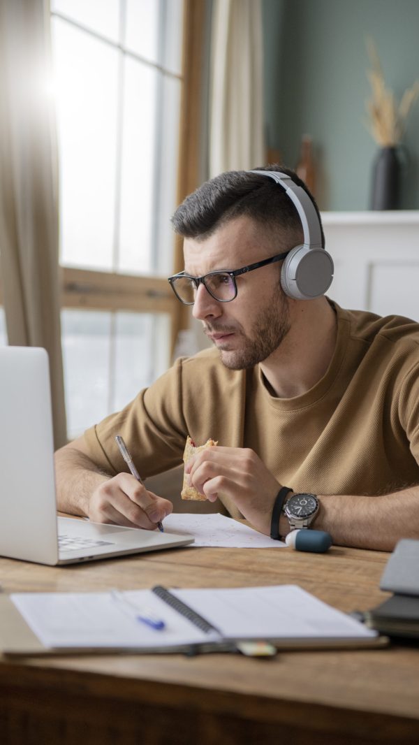 young-man-studying-library-using-laptop-scaled.jpg